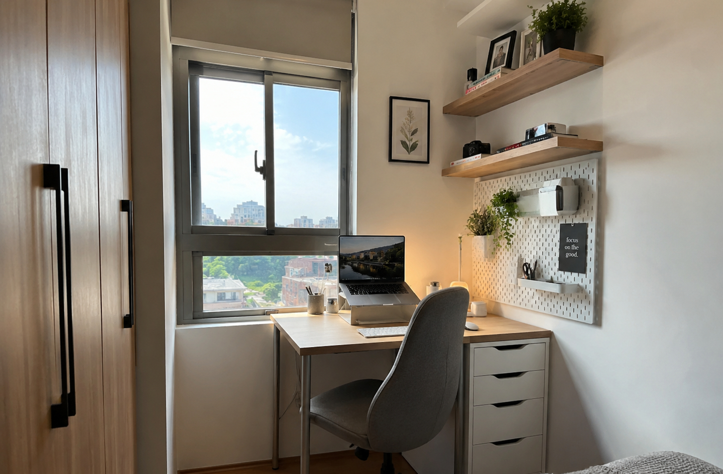Home office vertical storage with white pegboard and floating shelves above a compact desk