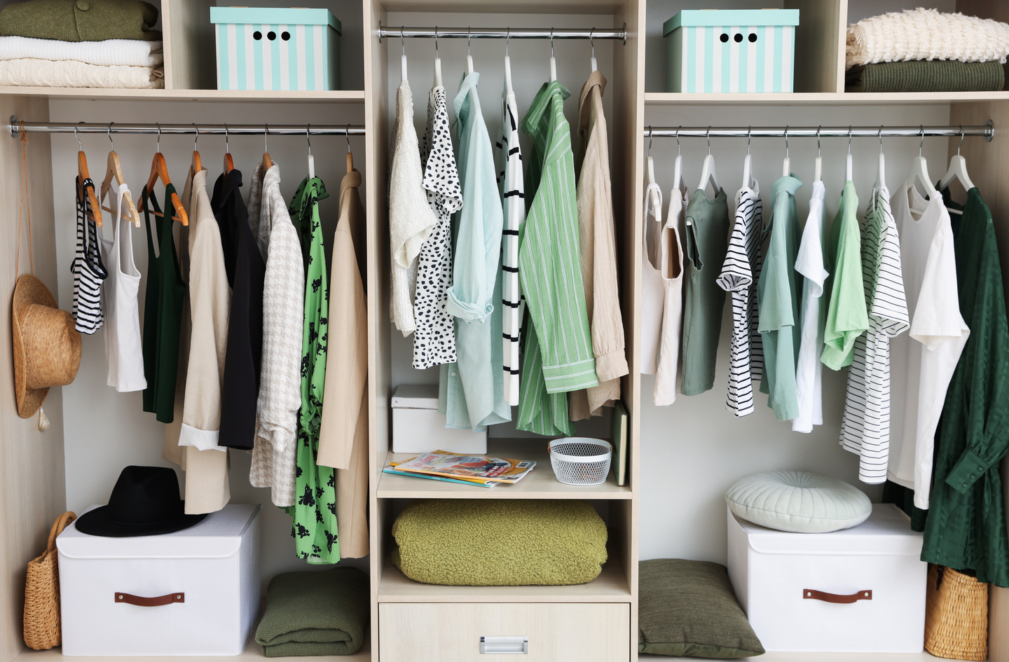 An organized closet with neatly stacked items on the top shelf and bins below, illustrating clear zone assignment by category
