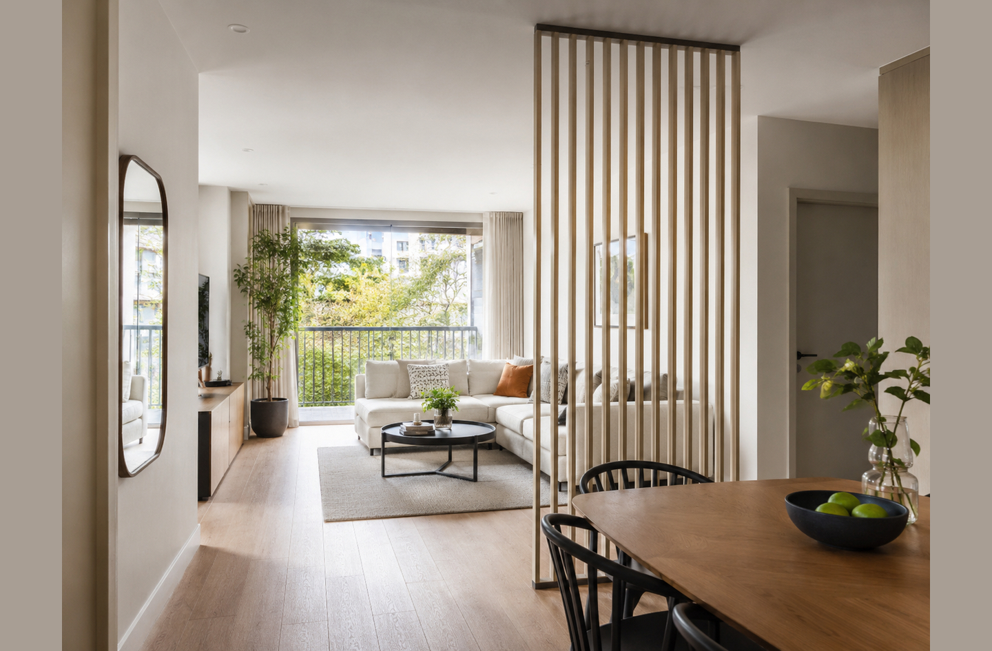 A floor-to-ceiling wood slat room divider separating a dining area from a living room while maintaining an open, light-filled feel